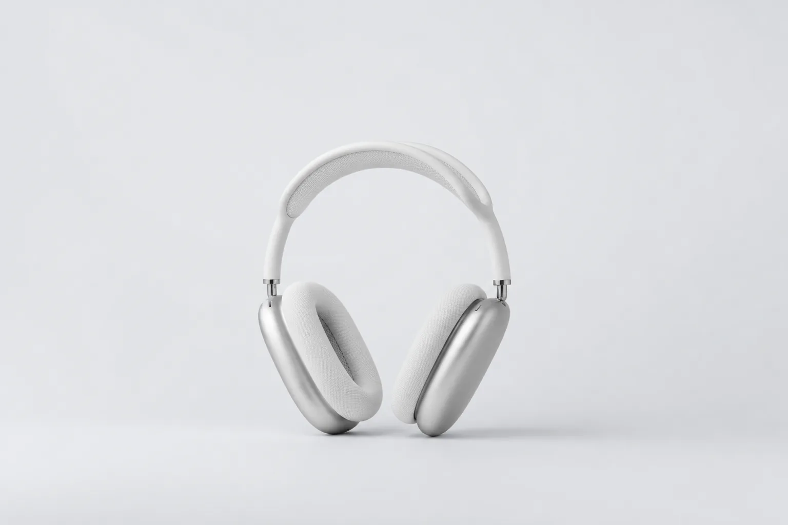White over-ear headphones on a pale grey backdrop