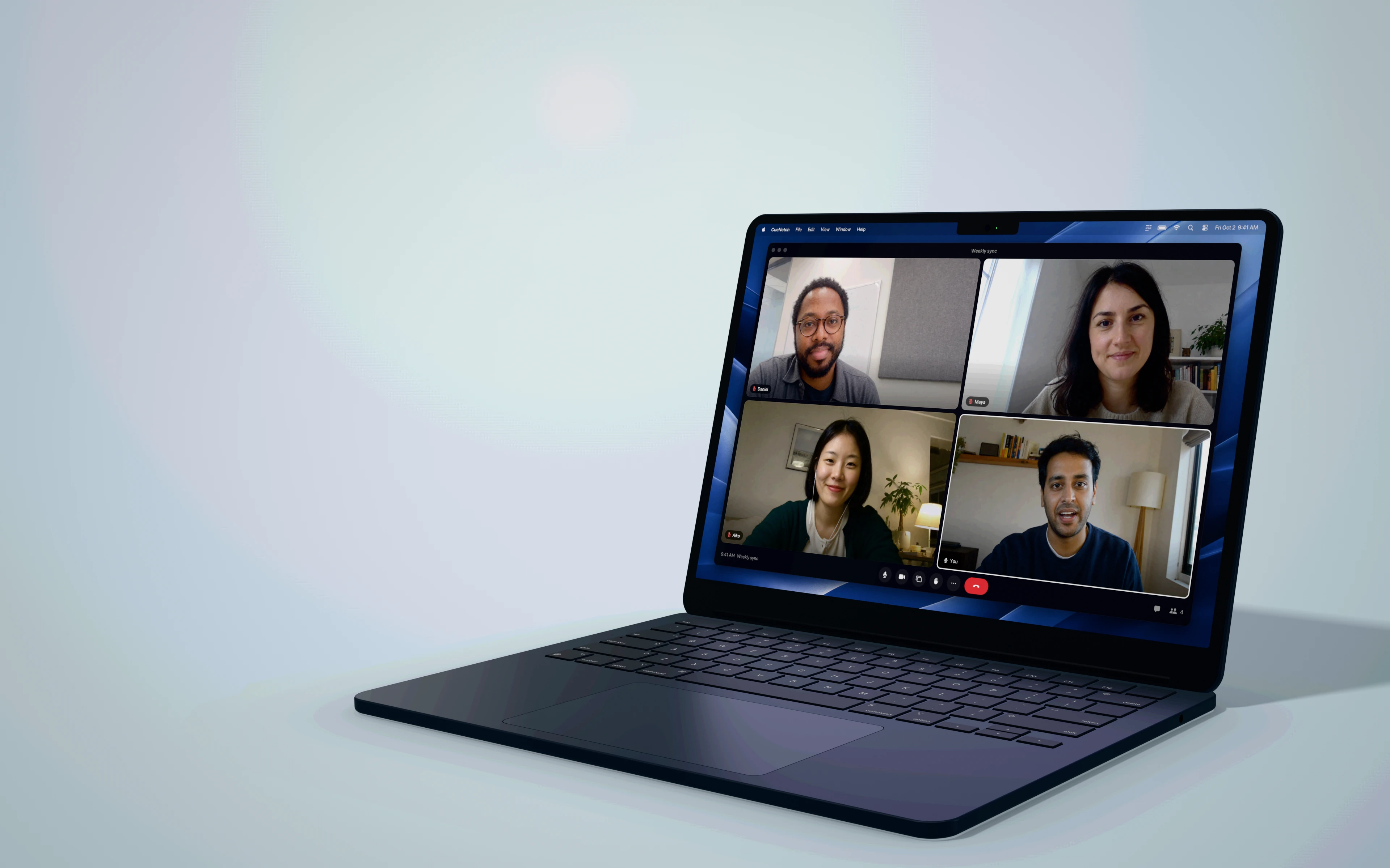 A MacBook on a video call with four people, the CueNotch prompter under the camera